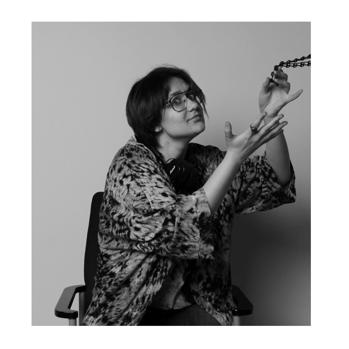 Black and white portrait of a gesticulating student in a leopard shirt
